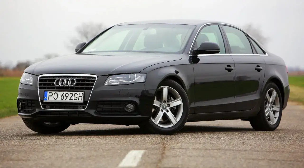 Czarne Audi A4 B8 z polskimi tablicami PO 692GH. Nowe żarówki w reflektorach dodają mu blasku.